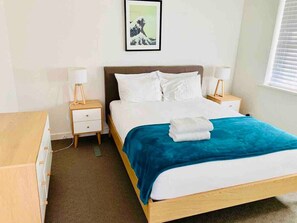 First bedroom with queen bed and comfortable pillows