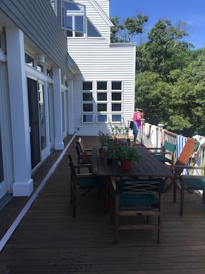 porch with picnic table that seats eight pax