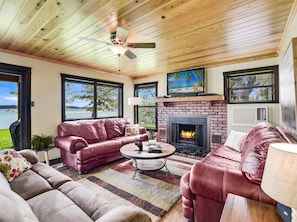 The living area in the main house includes a fireplace and lake views!