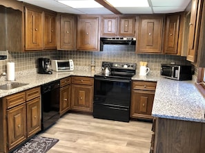 Kitchen with Stove, Dishwasher, Microwave, Toaster oven, Refrigerator.