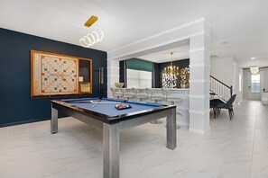 Pool table and wall scrabble in living room