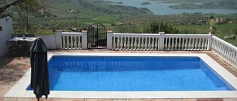 Relax by the private pool with amazing views over Lake Vinuela.