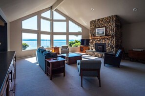 Living Room, with woodstove, TV, large seating area.