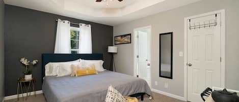 King size bed in master BR with memory foam mattress and blackout curtains.