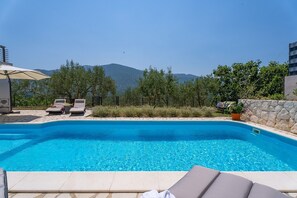 Sun deck area with 4 deck chairs and private pool
