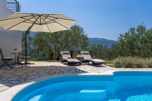 Sun deck area with 4 deck chairs and private pool
