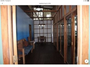 Living room, with hardwood floors, and custom opening glass doors