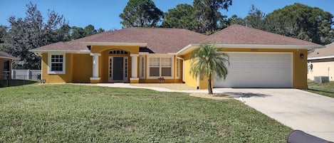 A street view of the property. There is a 2 car garage & parking on the driveway