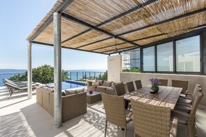 Summer kitchen, outdoor dining area, and lounge in the shadow