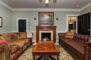 Living room with fireplace containing original yellow tile