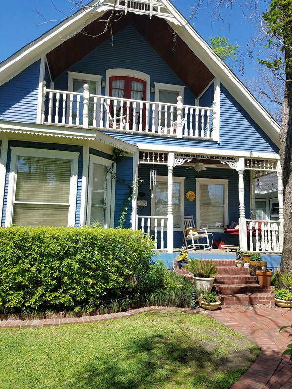 Front of home with upper and lower porches. Rockers and porch swing. 