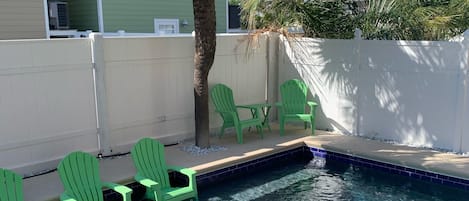 Private Pool with Chairs on Sun Shelf and Seating under shade of Palm Tree