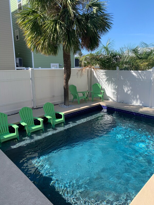 Private Pool with Chairs on Sun Shelf and Seating under shade of Palm Tree