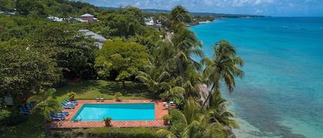 Birds eye view of the villa's pool and front garden - the beach is a minute stroll from the villa