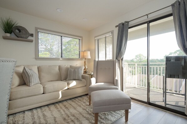 Carolina Beach Club 429 - Living Room - Charming bright living room and sliding door to balcony enjoy side view of the amazing  Atlantic Ocean .