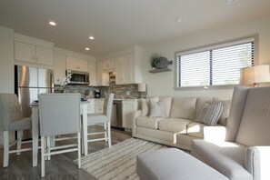 Carolina Beach Club 429 - Living Room - Charming bright living room and kitchen area. Newly renovated and upgraded all stainless steel appliance with new comfy furniture .