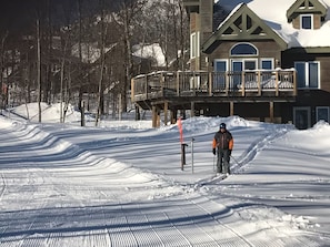 My husband skiing out of the house