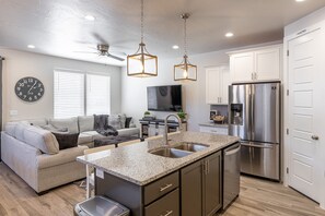 Kitchen View - This large living area is designed as an open floor plan and is a great gathering place for meals, games, or watching TV during your stay.