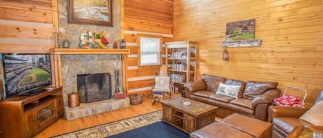 Living Room with Wood Burning Fire Place and Flat Screen TV