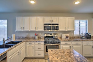 The kitchen boasts top-notch appliances and expansive countertops.