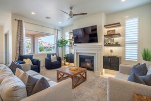 Spacious main floor living room with sofa seating, cable TV, and a fire place