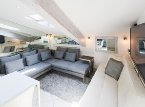 Living room with sofa group and extra bed: A chic living room ensemble with cozy sofas and an inviting extra bed, where comfort meets style.
