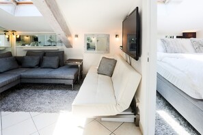 Living room with sofa group and extra bed: Embrace the charm of a living room adorned with sofas and a bonus bed, where relaxation knows no bounds.