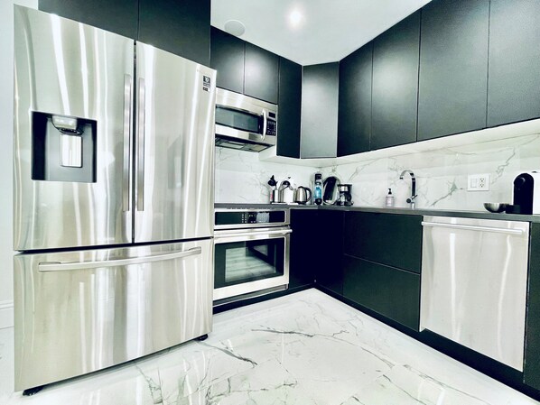 Kitchen with state-of-art induction cooktop, built-in oven, convection oven, dishwasher, French style refrigerator.

