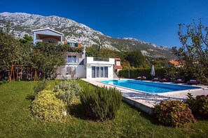 Spacious pool area with kids playground 