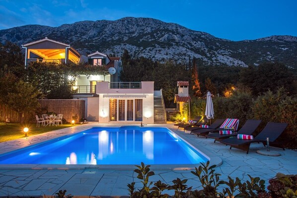 Night view of the villa and outside area.