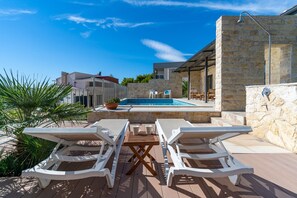 Private heated pool with 8 lounge chairs