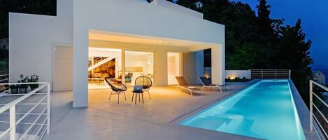 Sun deck area with 27m2 pool, lounge chairs and outdoor furniture