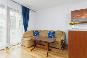 A cozy living space featuring a brown sofa, coffee table, and simple decorative elements.