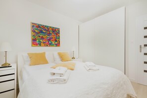 The cosy bedroom features a luxurious double bed and ample storage.