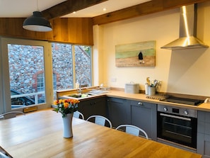 The brand new fitted kitchen with a electric hob and oven