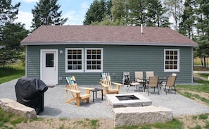 back patio with grill, fire pit, table and chairs
