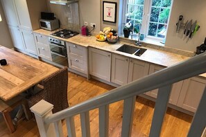 Stairs lead upstairs from within the kitchen/dining area