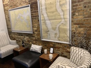 A delightful seating area with a large leather ottoman used as a seat or table. 