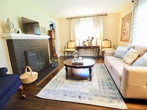 Enjoy a great conversation with family or catch up with friends in our spacious Living room. Antique blue armchair and two matching Josephine style French chairs for more conversation seating. Sofa with pull out full-size bed option.
