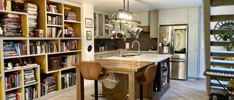 Kitchen Island has a built in dining butcher block table.