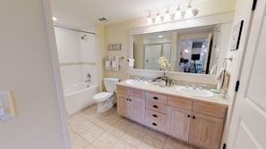 Large double size bath, has a separate shower and a shower bath.
