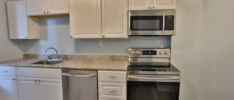 Newly renovated kitchen with granite counters and stainless appliances