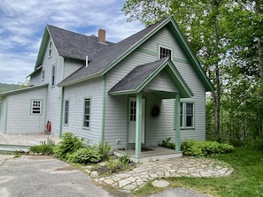 Front entrance with plenty of parking and basketball hoop.