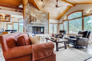 Great room with large windows fireplace