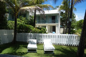 lounge chairs in garden area and view at neighboring Coconut and Seaview Studio