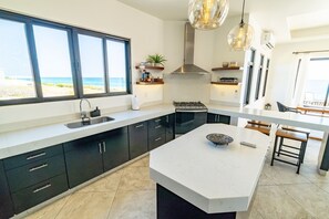 Kitchen opens to dining and terrace