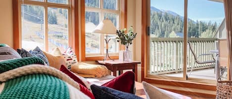 Living room with a front row view of the ski hill and surrounding mountains