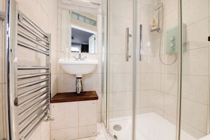 Modern Bathroom: Sleek glass shower and chic fixtures for a refreshing escape!