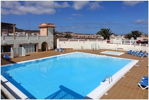 Large 20m communal pool with separate toddler pool and sun loungers