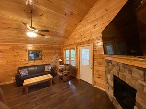 Family Room - Queen sleeper sofa, 65" TV, electric fireplace, & access to deck